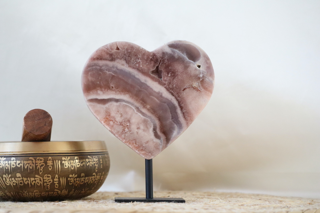 Gelaagd roze chalcedoon hart op zwarte metalen standaard