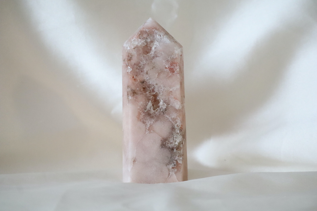 Roze chalcedoon met kwarts toren met zachte poederroze tinten en kleine kristalinsluiting, gepolijst en gefotografeerd in natuurlijk daglicht.