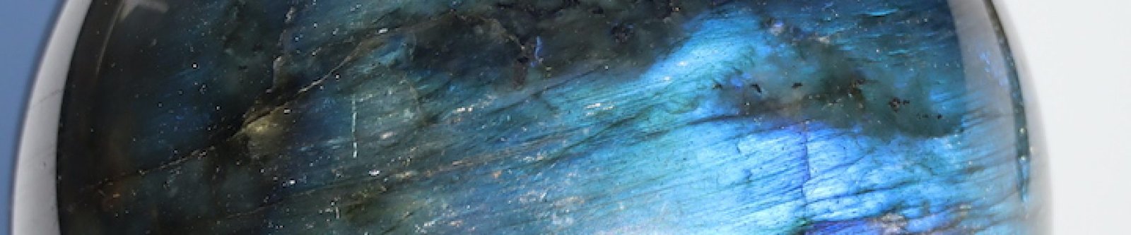 Detail van Labradoriet bol met glanzende groen-blauwe labradorescentie